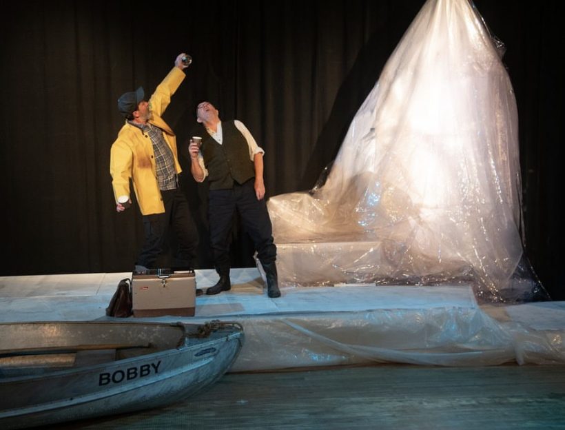 Two actors raising a toast beside an iceberg set