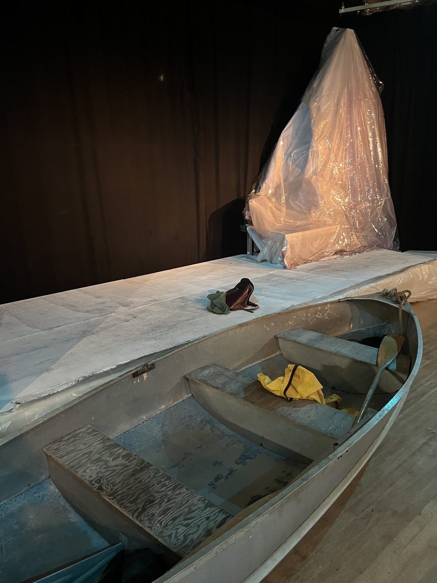 Stage set with a rowboat and a plastic iceberg